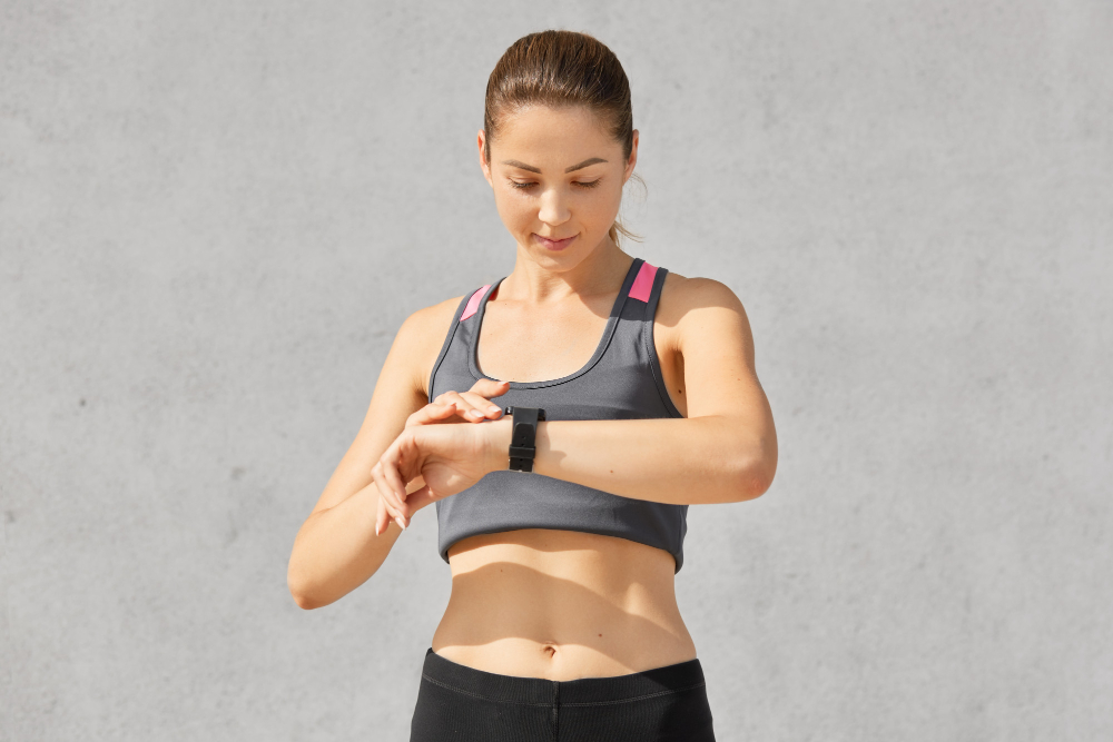 Woman checking fitness tracker during workout session