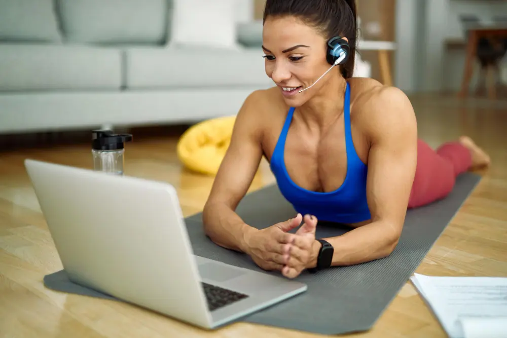 Female online fitness coach using PT Distinction app during a virtual training session