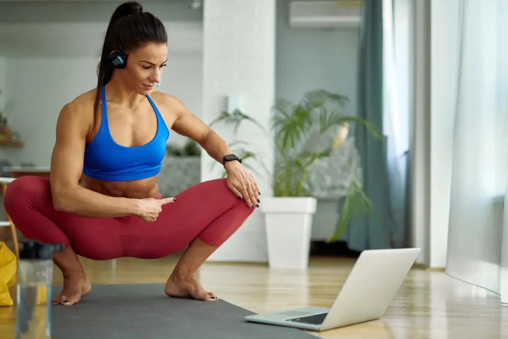 Personal trainer connecting with clients virtually during a home training session