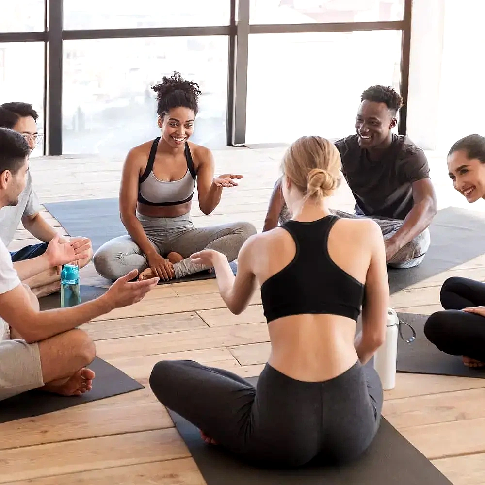 Zenoti wellness community yoga session highlighting group engagement and fitness experience