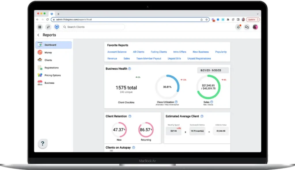 fitDEGREE business health dashboard on MacBook showing client check-ins, retention analytics, sales reports, and class utilization insights for fitness studios.