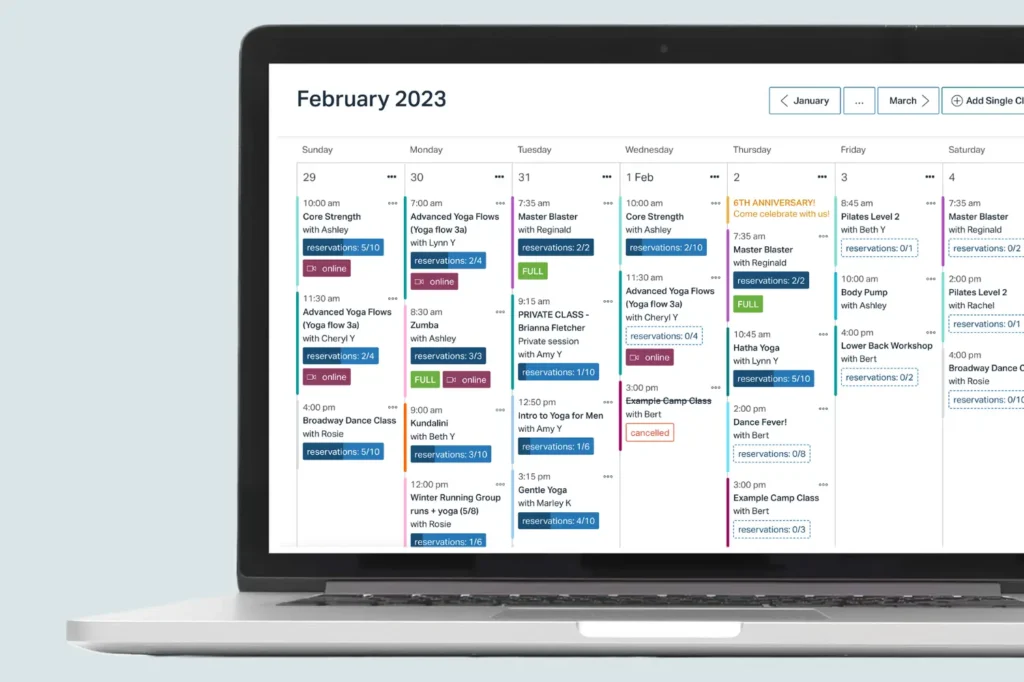 Punchpass class schedule calendar displayed on laptop showing weekly yoga, dance, and fitness classes.
